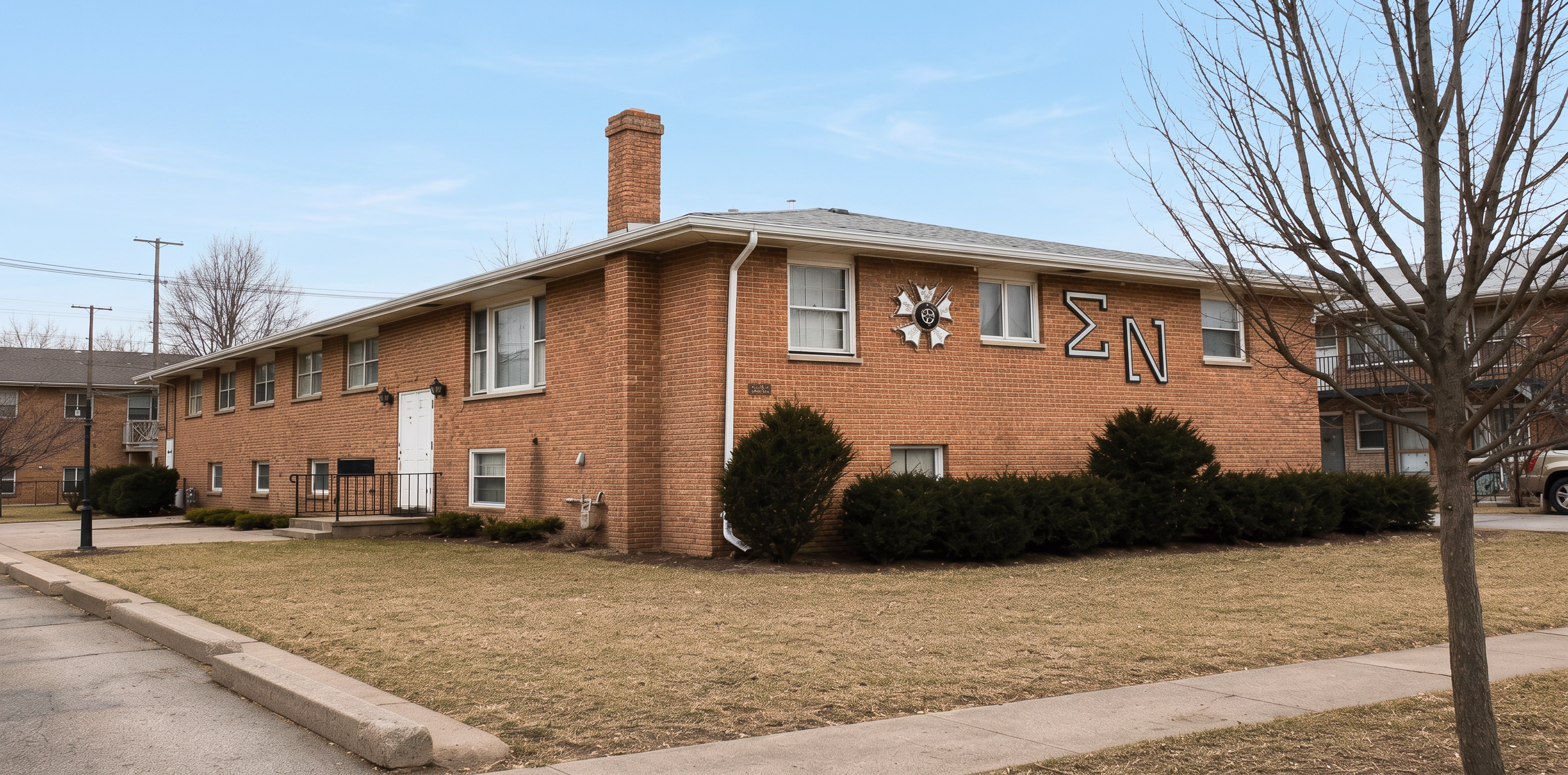 Undergraduate brothers proudly display the framed “NIU’s Leading Fraternity” poster, a central theme and source of pride for Theta Eta, representing the chapter’s commitment to leadership, excellence, brotherhood, and distinction at Northern Illinois University.